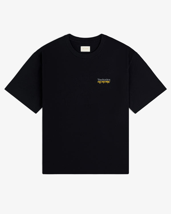 ALD / Technics Logo Tee: Black short-sleeve shirt with small white and yellow logo text on the left chest.