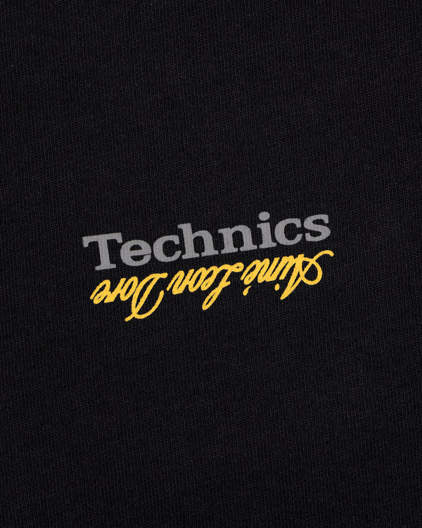 Black ALD / Technics Logo Tee with gray Technics and yellow aline icon doro, both printed upside down.