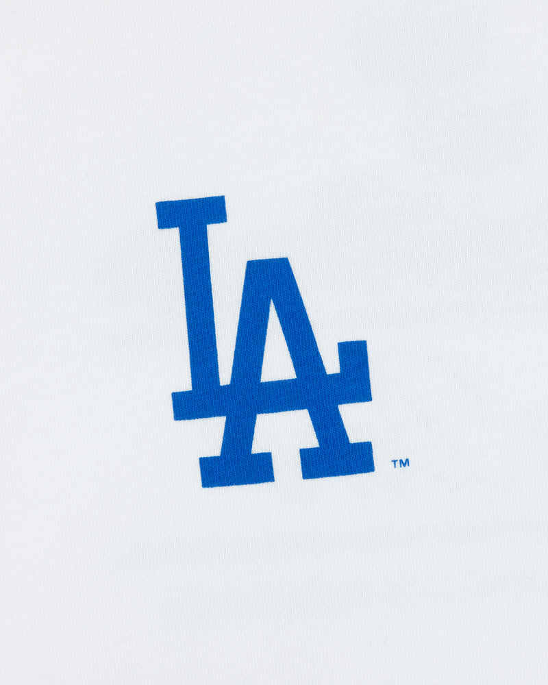 Blue LA logo on white tee, representing the Los Angeles Dodgers. Product: ALD / LA Dodgers Unisphere Tee.
