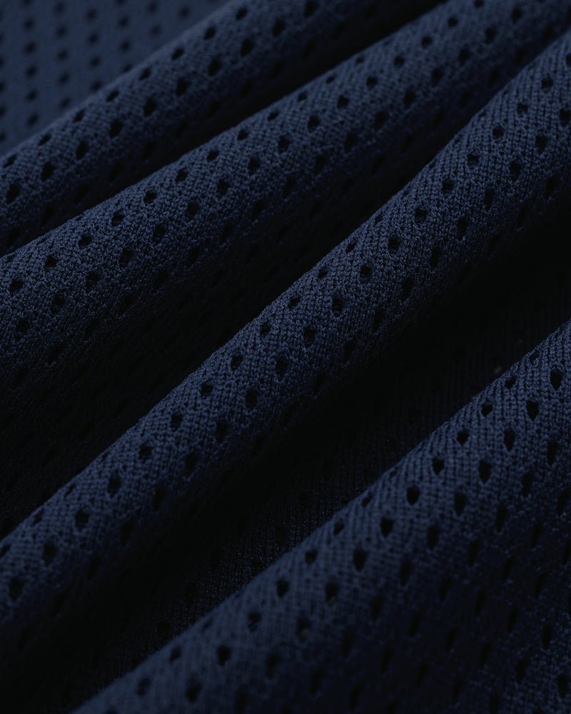 Close-up of dark blue Mesh Batting Practice Jersey showing perforated texture and fabric folds.