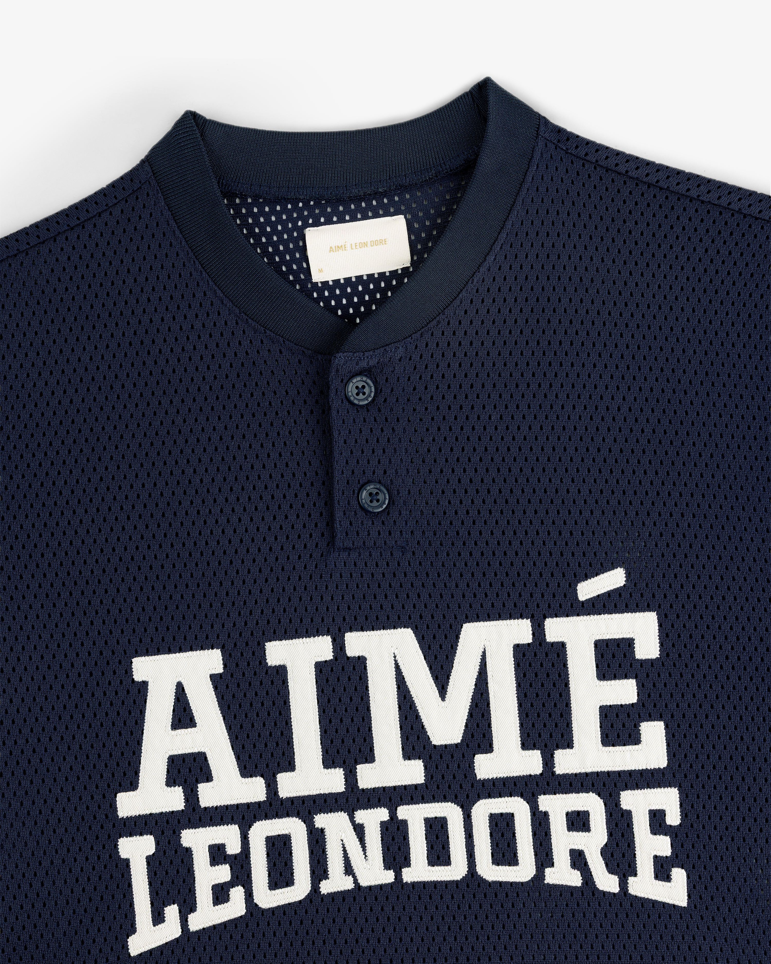 Navy Mesh Batting Practice Jersey with white AIMÉ LEON DORE text and two buttons at the collar.