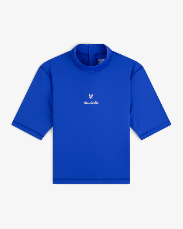 Bright blue Short Sleeve Crest Rash Guard with high neck, back zipper, and small white chest logo and text.