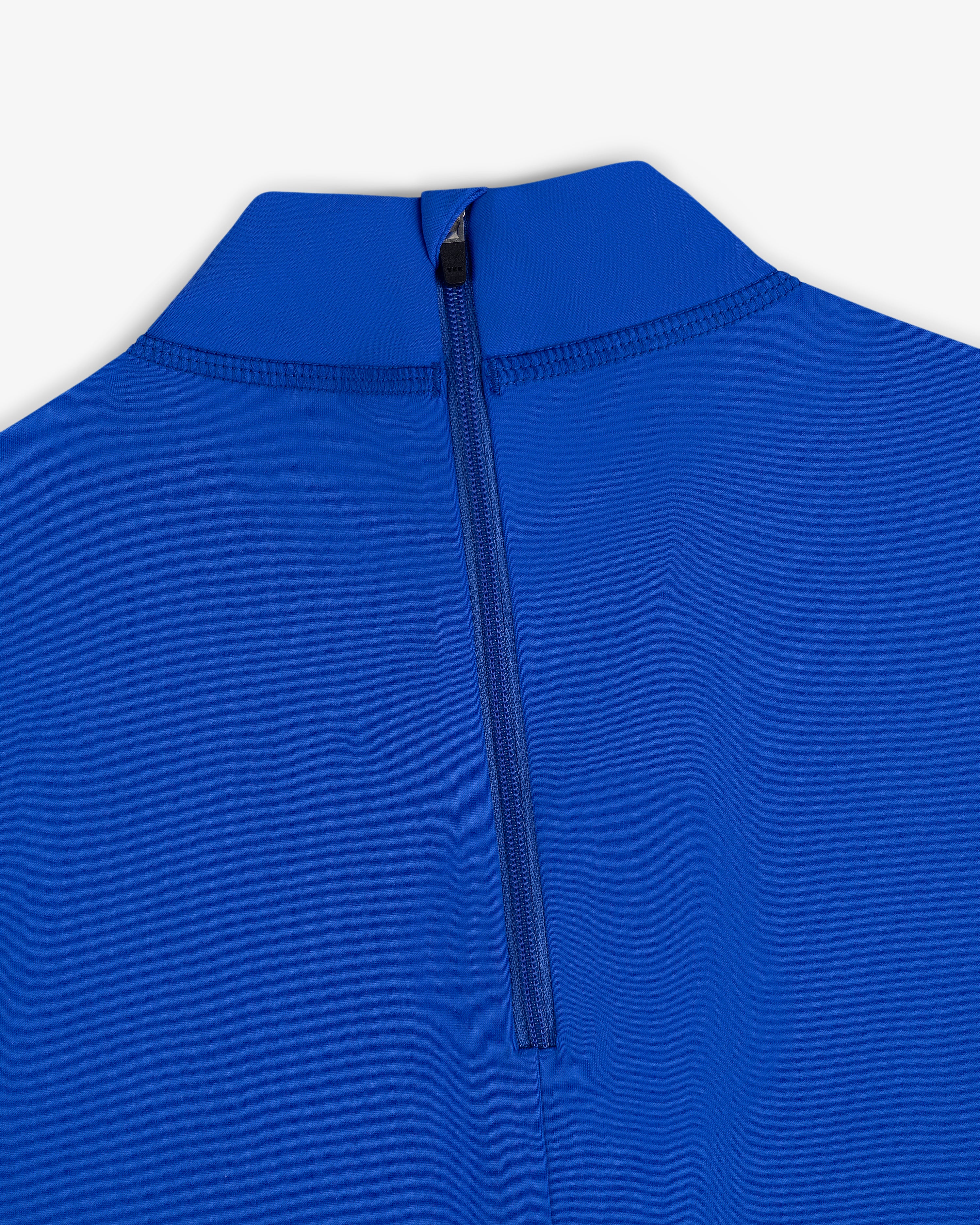 Close-up of a blue Short Sleeve Crest Rash Guard with a high collar and centered back zipper against a white background.