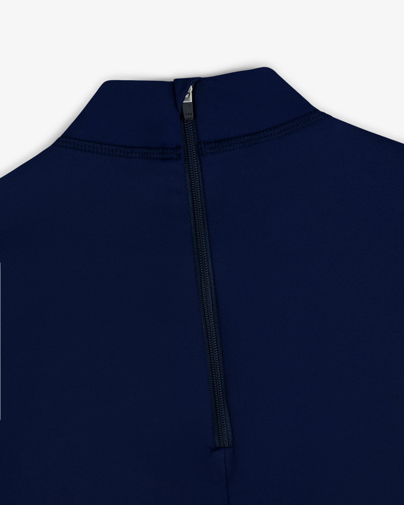 Close-up of the Short Sleeve Crest Rash Guard in navy blue, featuring a black back zipper and high collar on white background.