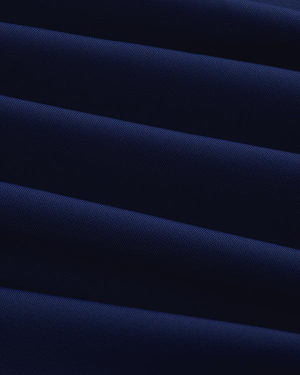 Close-up of the Short Sleeve Crest Rash Guard, showing folded dark blue fabric with ridged, diagonal texture.