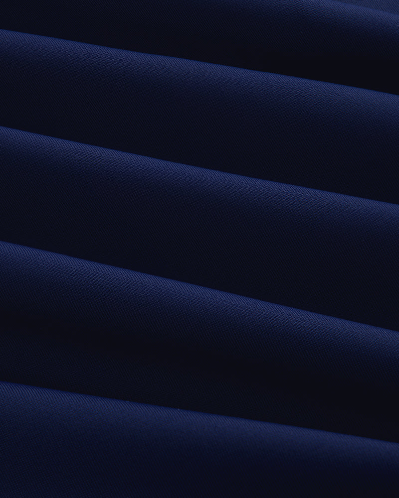 Close-up of the Short Sleeve Crest Rash Guard, showing folded dark blue fabric with ridged, diagonal texture.