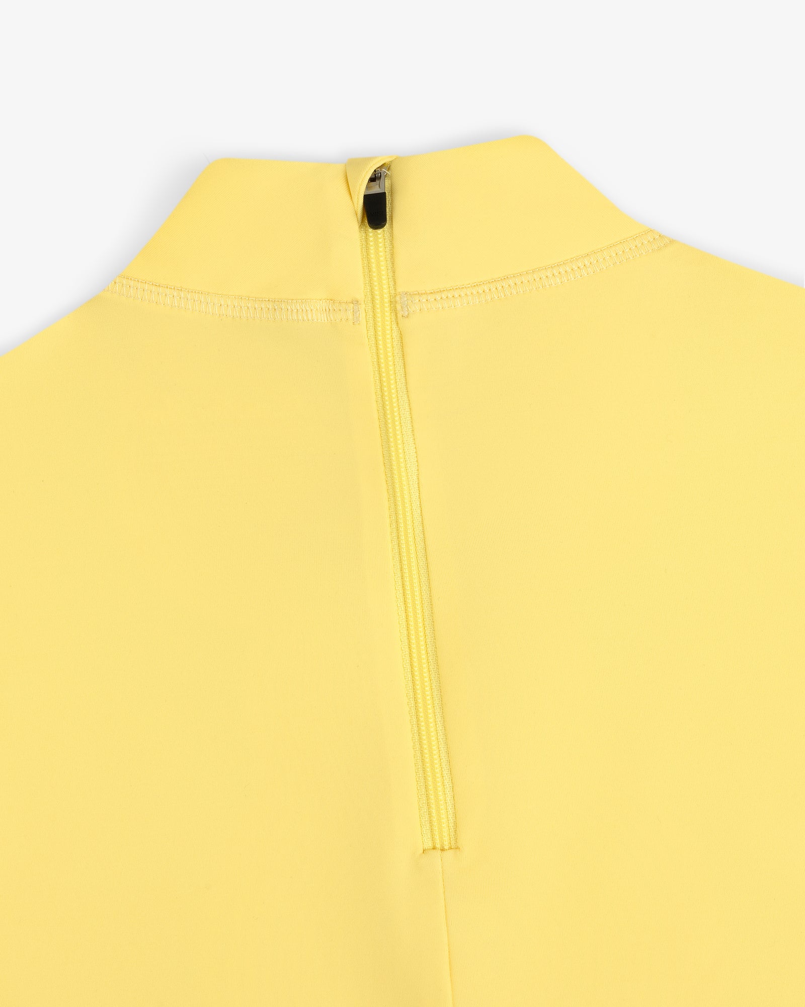 Close-up of the Short Sleeve Crest Rash Guard in yellow with a back zipper and high collar on a white background.