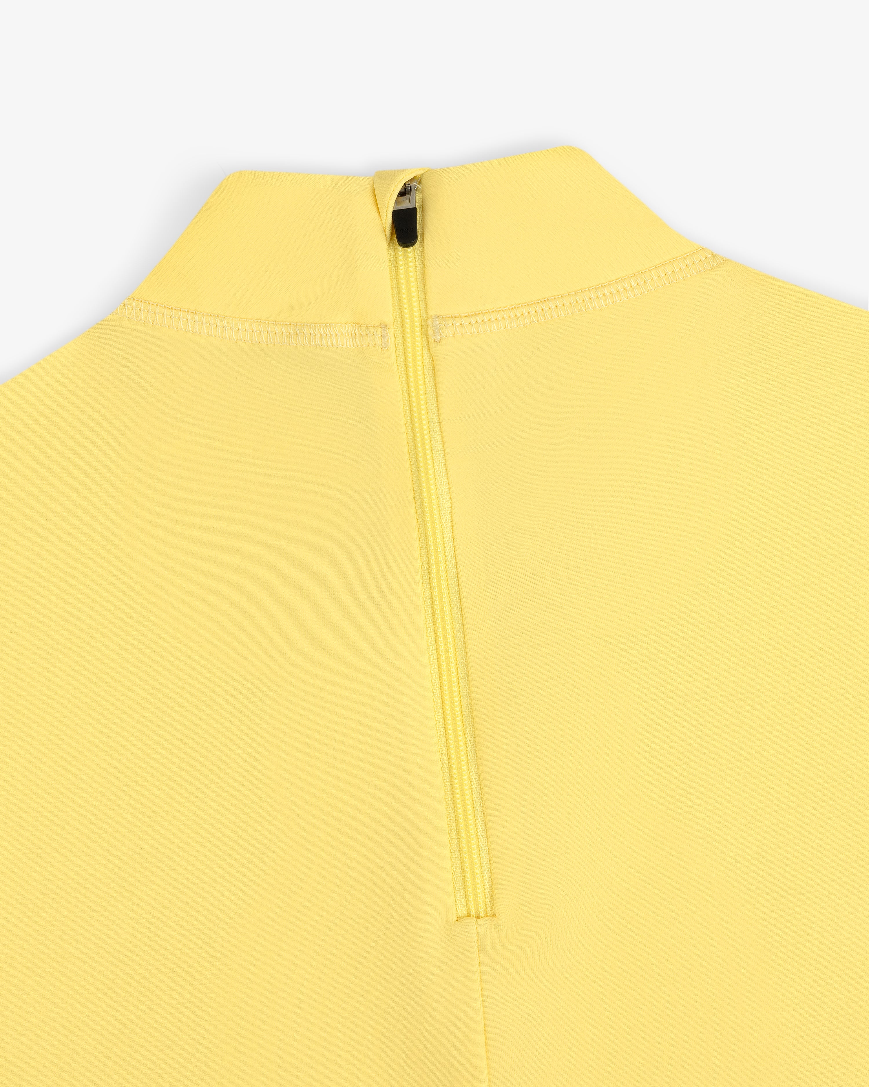 Close-up of the Short Sleeve Crest Rash Guard in yellow with a back zipper and high collar on a white background.
