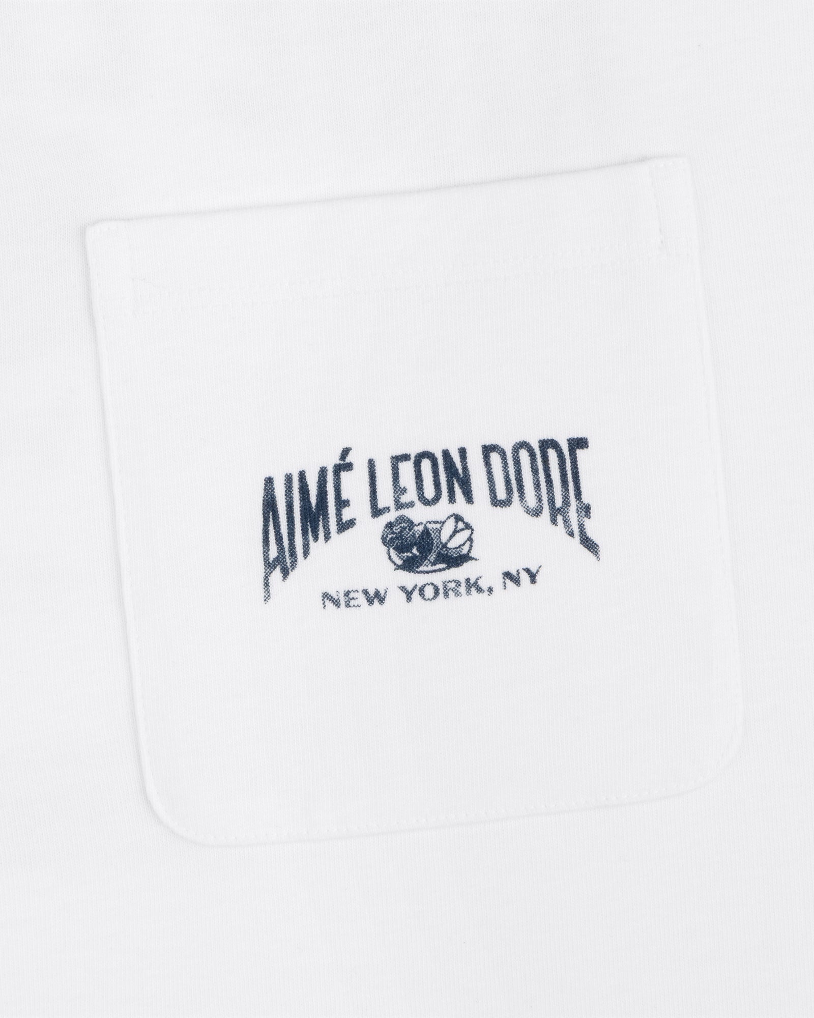 Neighborhood Pocket Tee with "Aimé Leon Dore New York, NY" and floral graphic embroidered on the white shirt pocket.