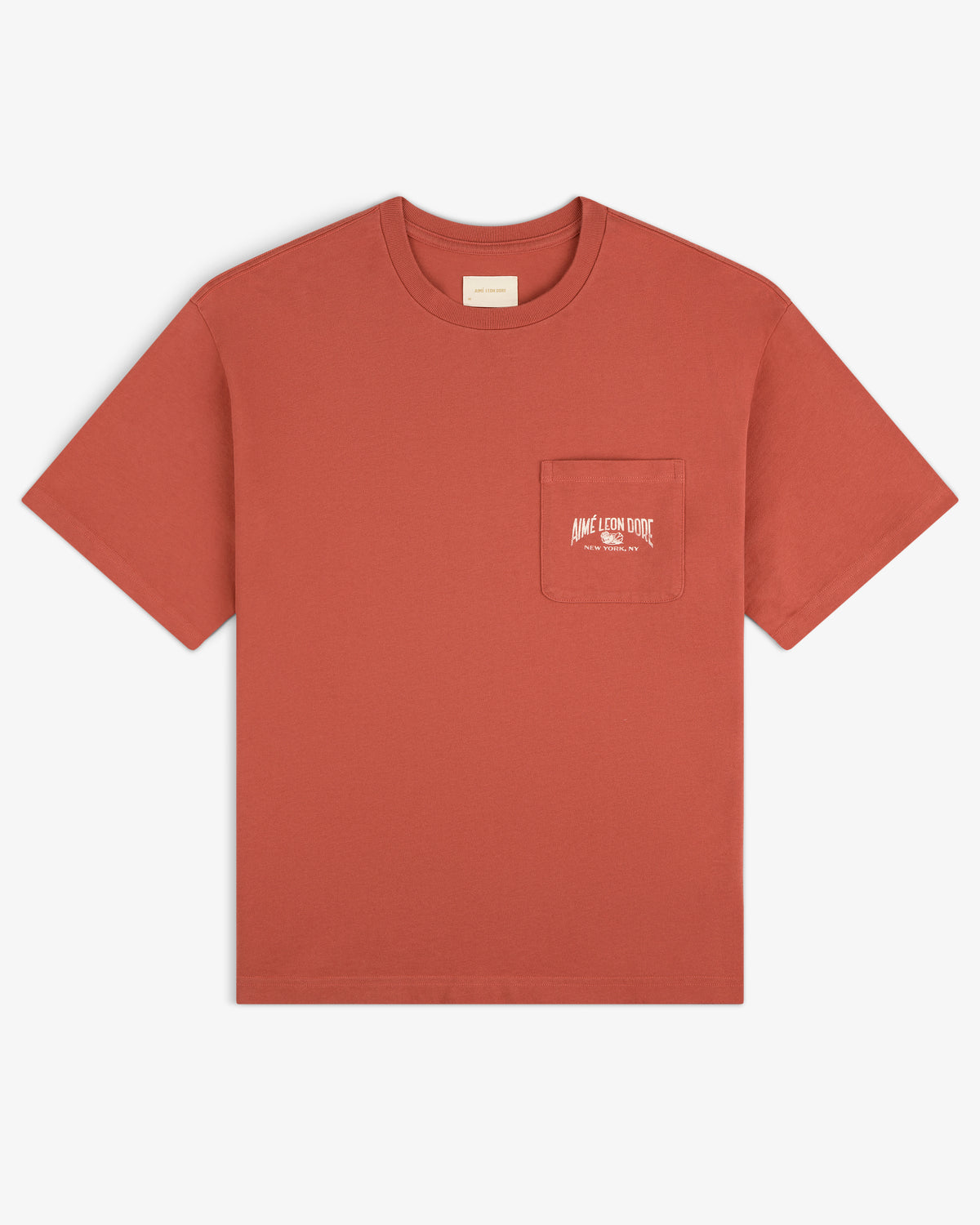 Neighborhood Pocket Tee in rust with short sleeves, chest pocket, and small white logo plus text.