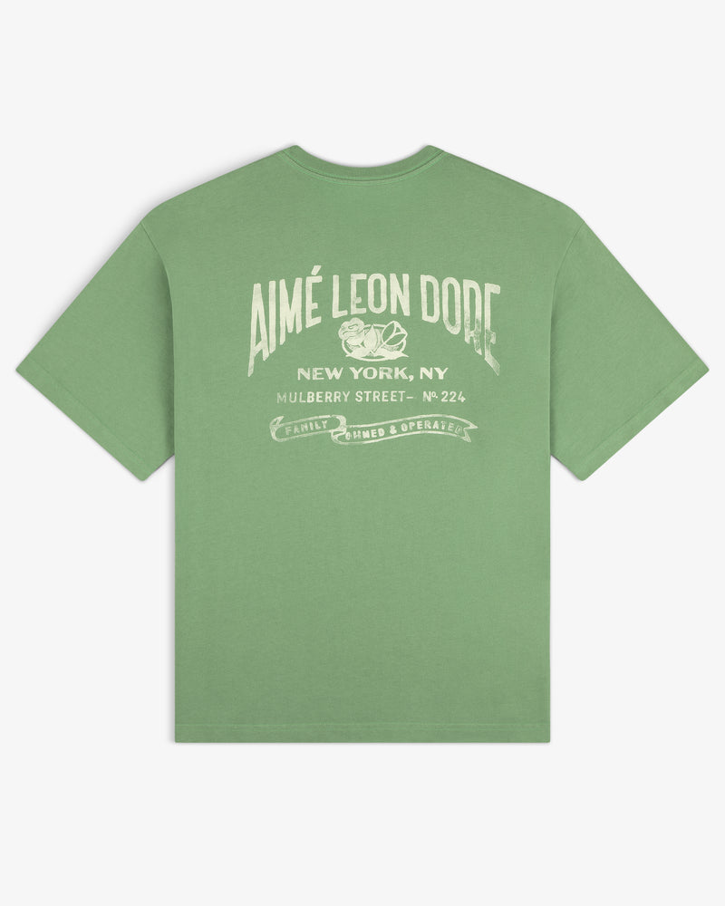 Neighborhood Pocket Tee featuring “AIMÉ LEON DORE New York, NY Mulberry Street” and white back graphic.
