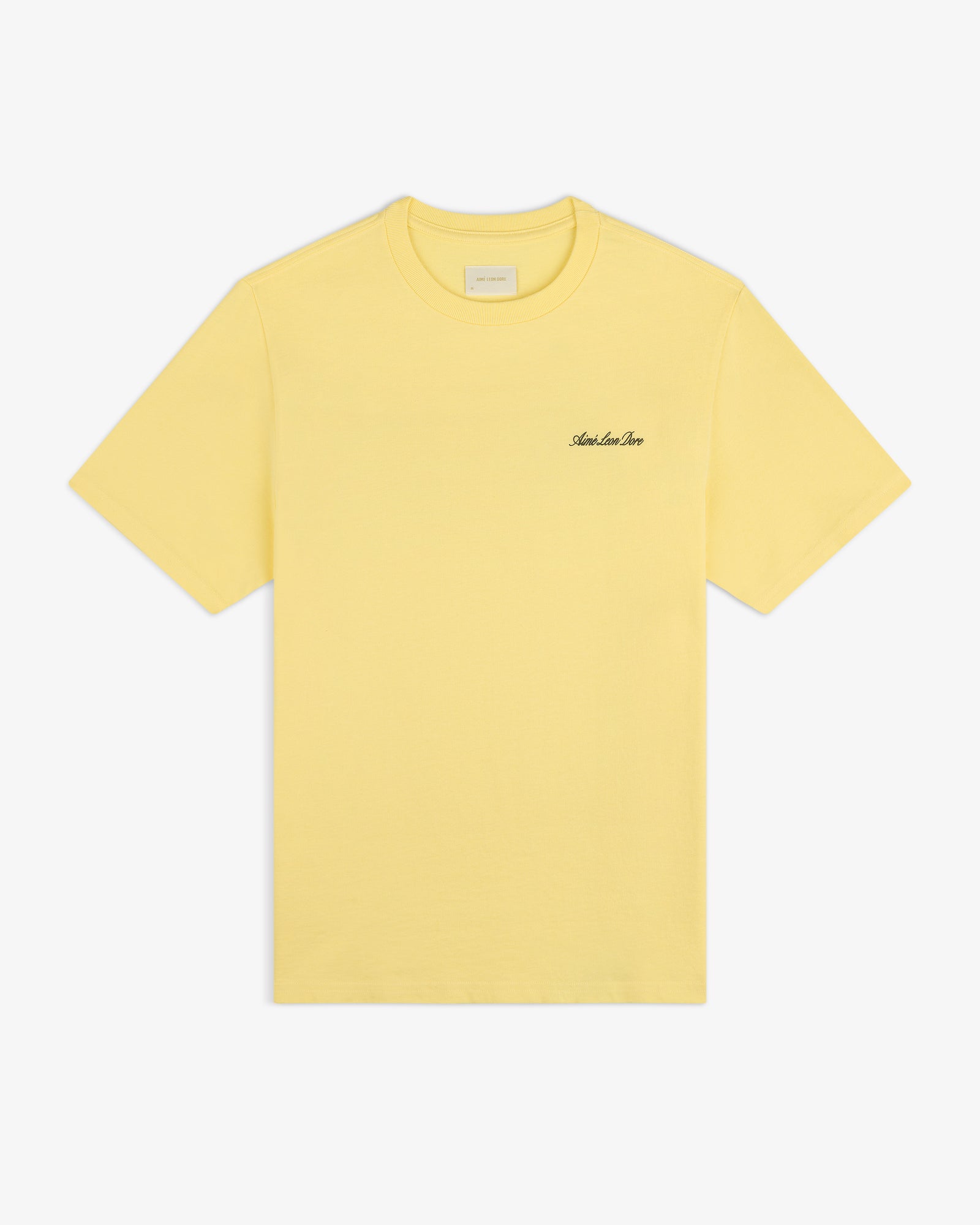 Super Cub Tee: yellow short-sleeve shirt with small black cursive text on the left chest, shown on white background.