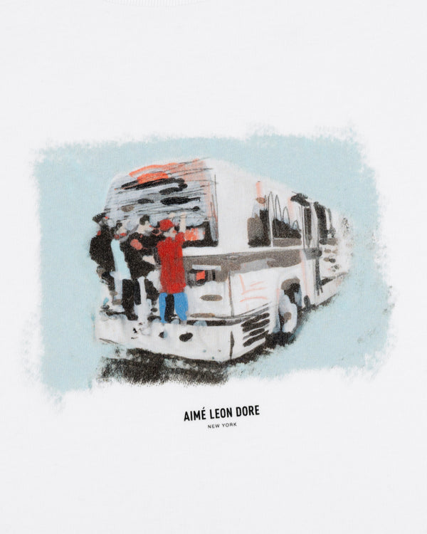Impressionistic art of people boarding a bus with "Mesaikos Commuter Tee" text below on a white background.