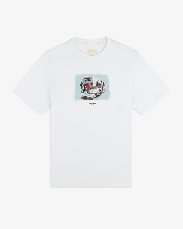 Mesaikos Commuter Tee: White shirt with a small truck and two people graphic plus text on the front.