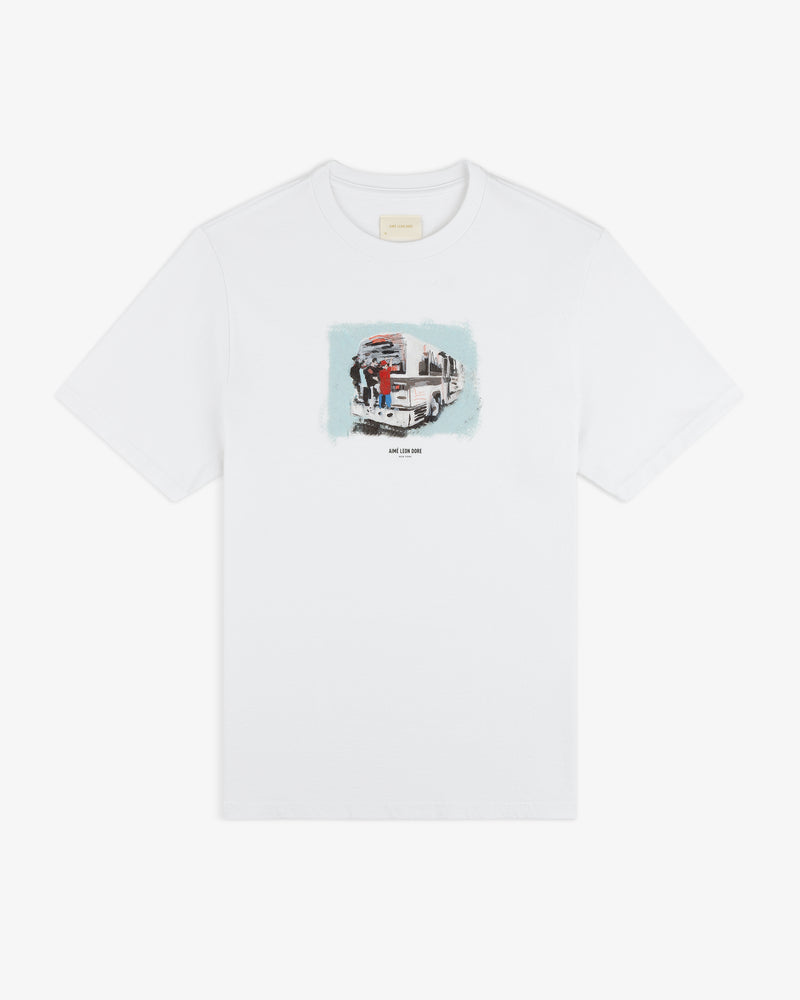 Mesaikos Commuter Tee: White shirt with a small truck and two people graphic plus text on the front.