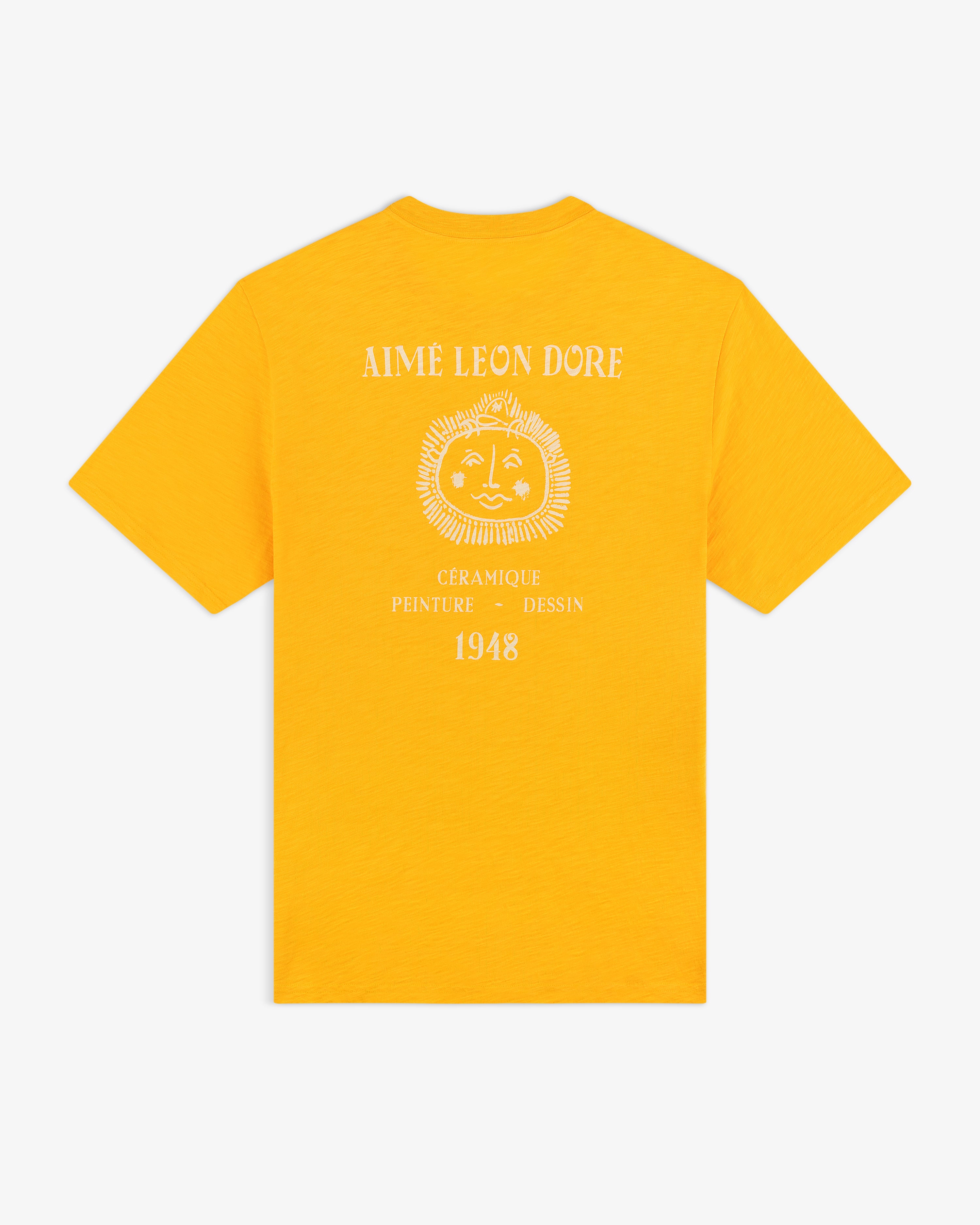 Bright yellow Artiste Pocket Tee with a sun face graphic and "Aime Leon Dore, Céramique, Peinture, Dessin, 1948" on back.