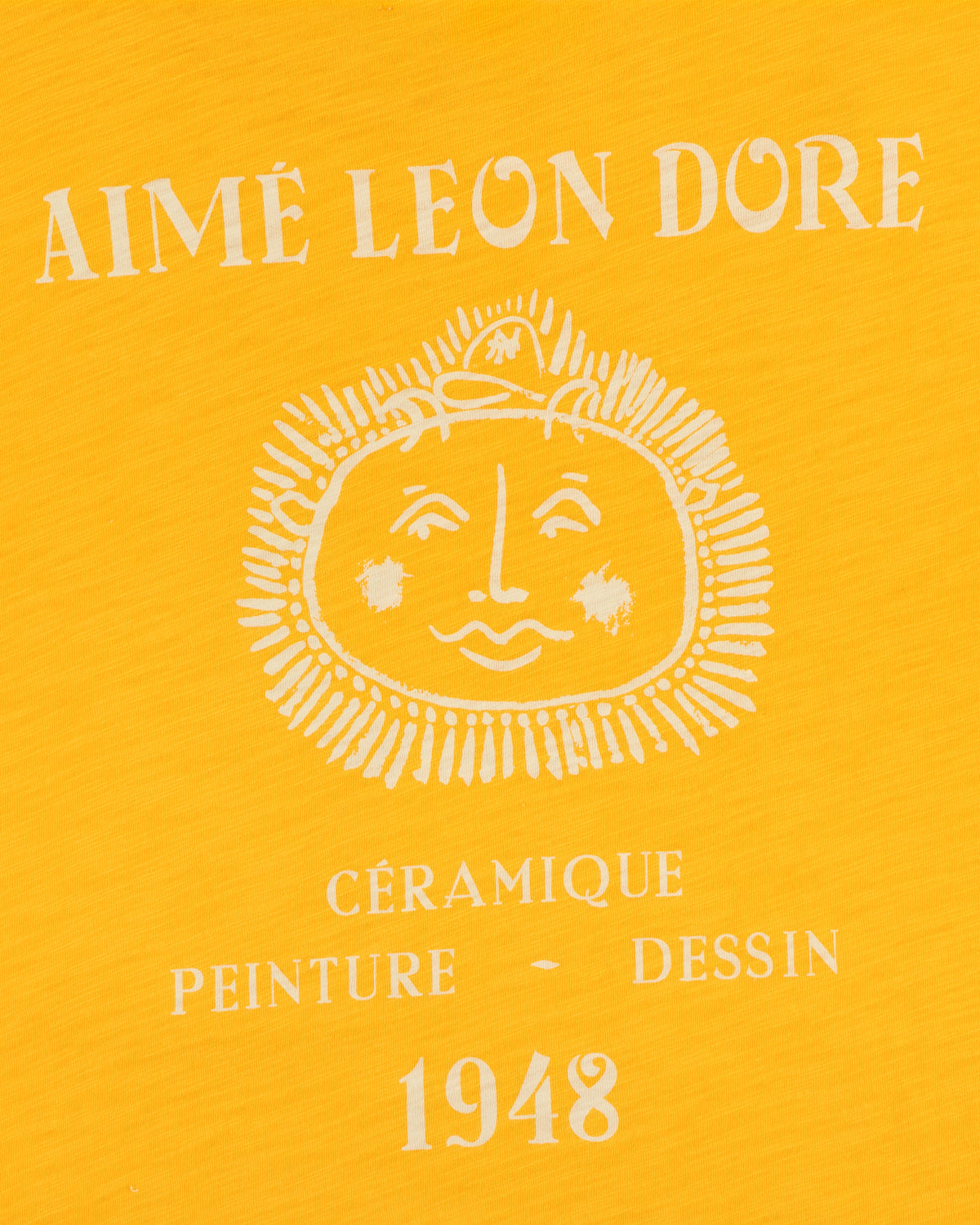Yellow background Artiste Pocket Tee with AIMÉ LEON DORE, sun face, and CÉRAMIQUE PEINTURE DESSIN 1948 text.