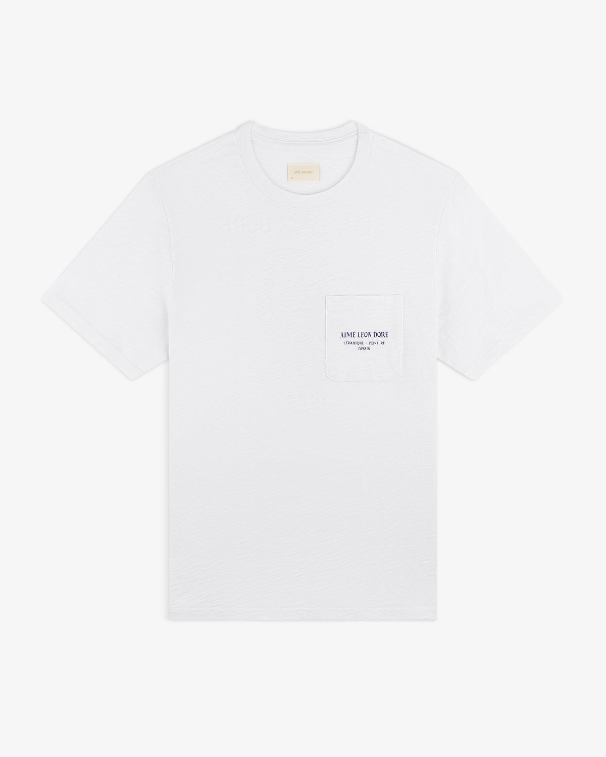 Artiste Pocket Tee: white short-sleeve t-shirt with chest pocket, small printed logo, and text.