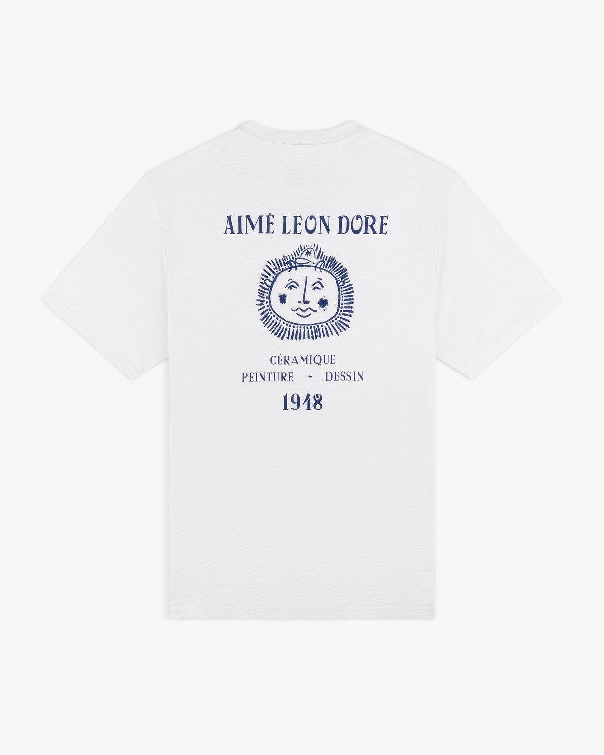 Artiste Pocket Tee: white tee with blue lion graphic and “AIMÉ LEON DORE, CÉRAMIQUE PEINTURE DESSIN 1948” on back.