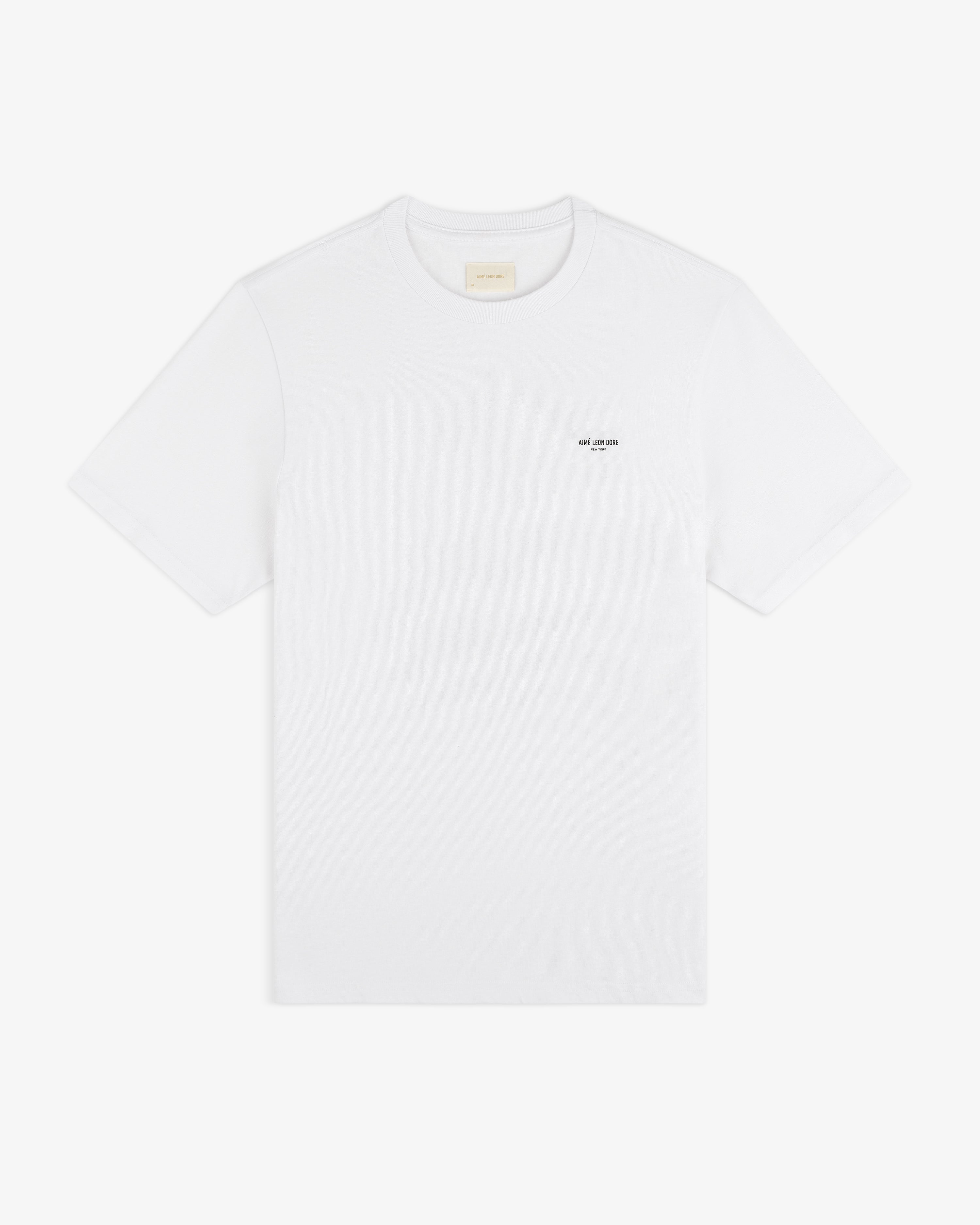 Mott Street Tee: plain white short-sleeve shirt with a small black logo printed on the left chest.