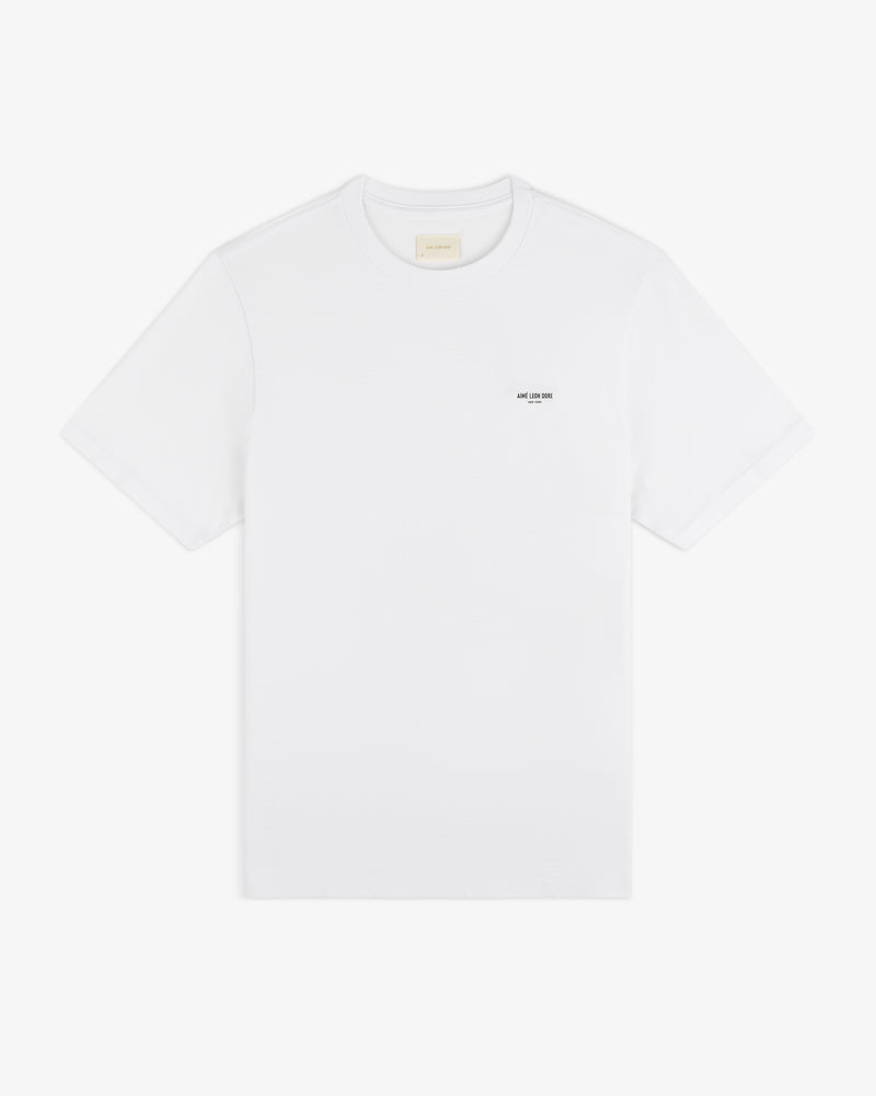 Mott Street Tee: plain white short-sleeve shirt with a small black logo printed on the left chest.