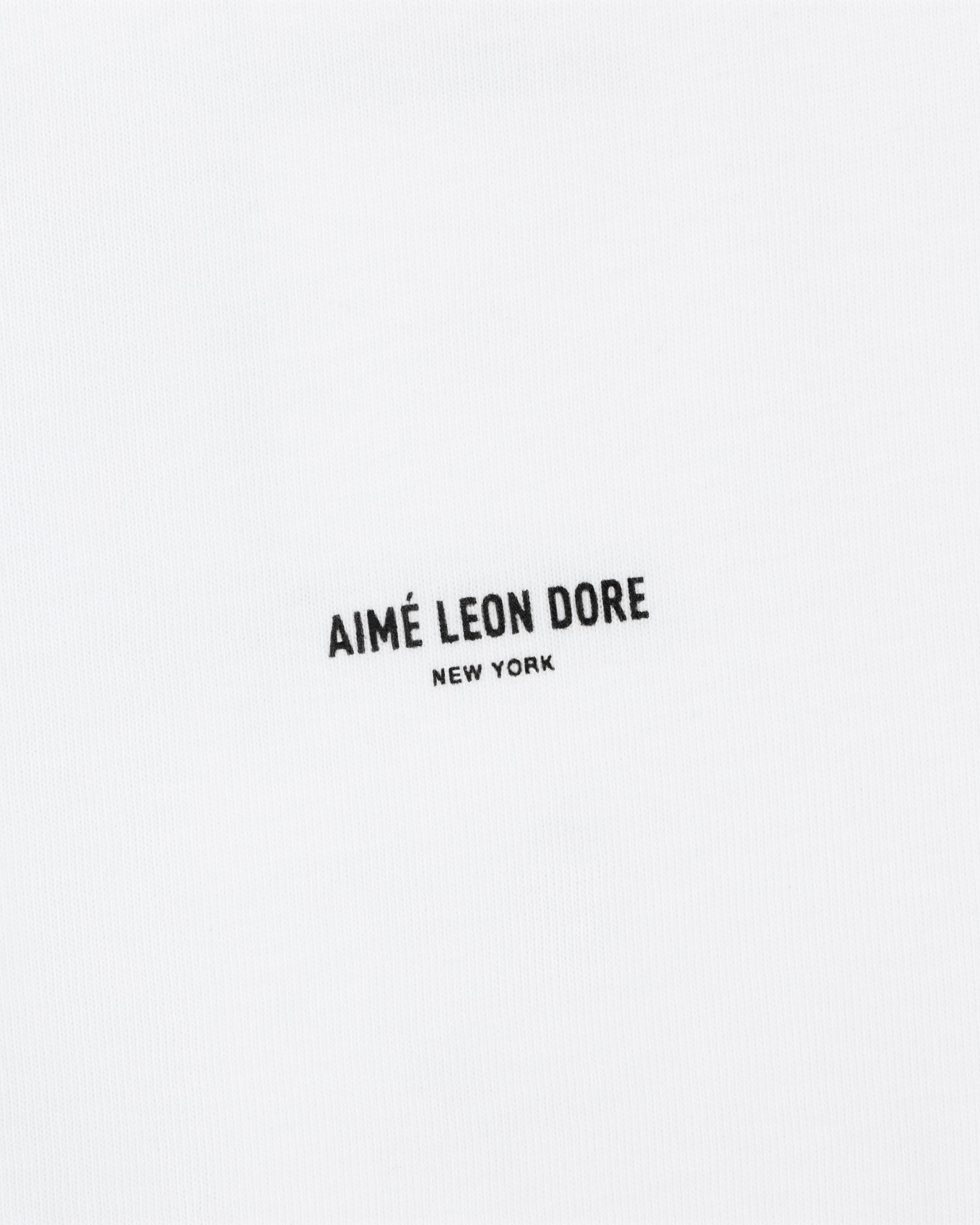The Mott Street Tee features white fabric with "AIMÉ LEON DORE NEW YORK" printed in small black letters at the center.