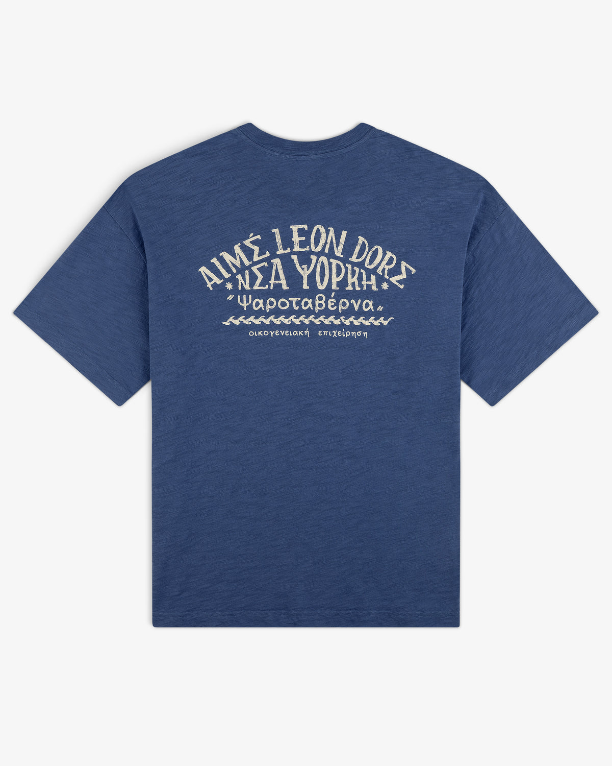 Taverna Tee: Blue shirt with white Greek and English text and graphics on back, reads AIMÉ LEON DORE ΝΕΑ ΥΟΡΚΗ.