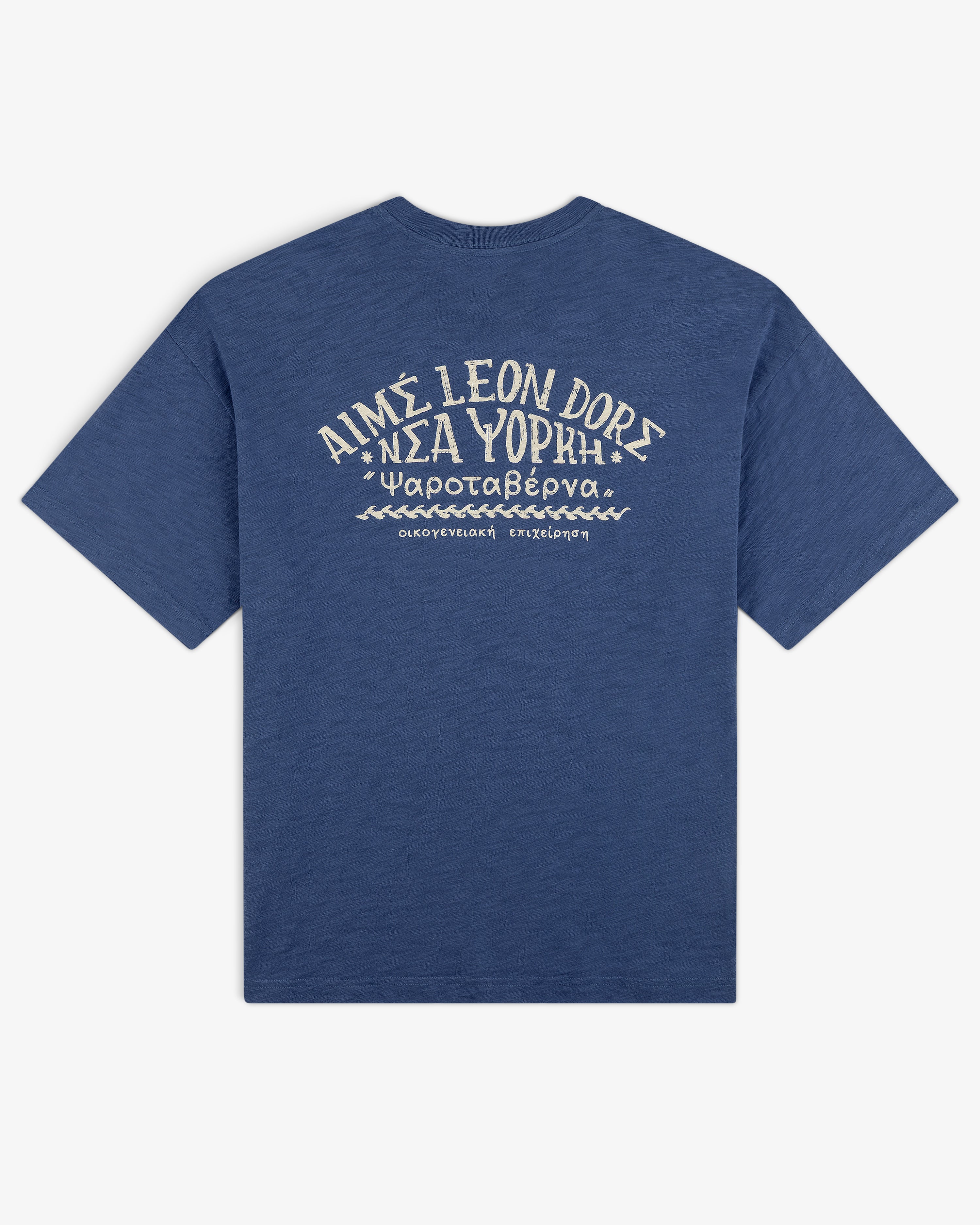 Taverna Tee: Blue shirt with white Greek and English text and graphics on back, reads AIMÉ LEON DORE ΝΕΑ ΥΟΡΚΗ.