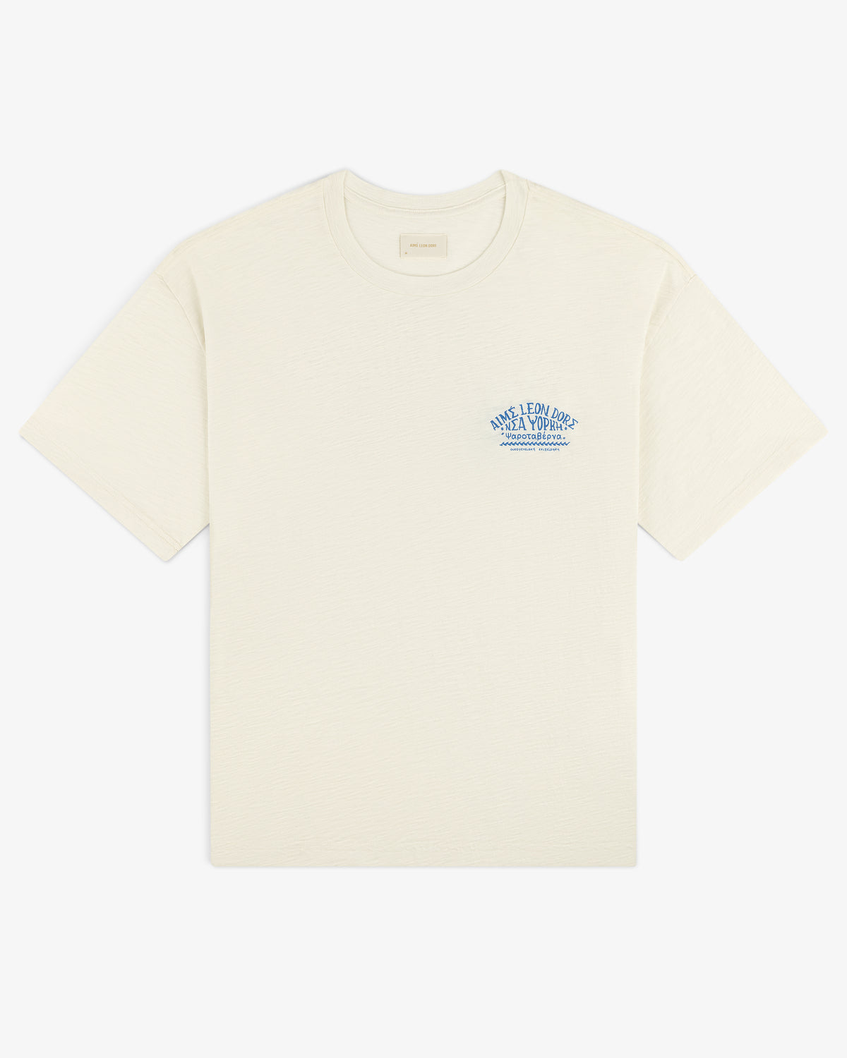 Taverna Tee: Off-white short-sleeve shirt with small blue text and graphic on the left chest.