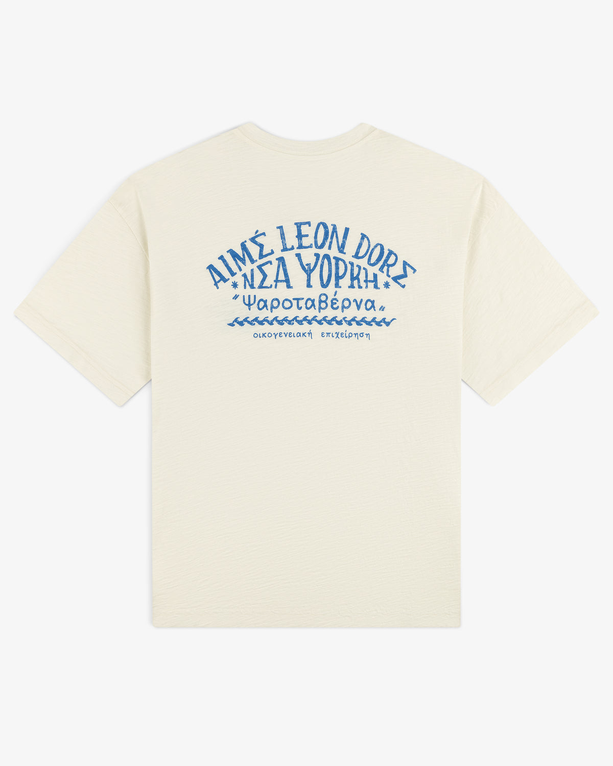 Off-white Taverna Tee with blue Greek text and "AIMÉ LEON DORE" in stylized letters on the back.