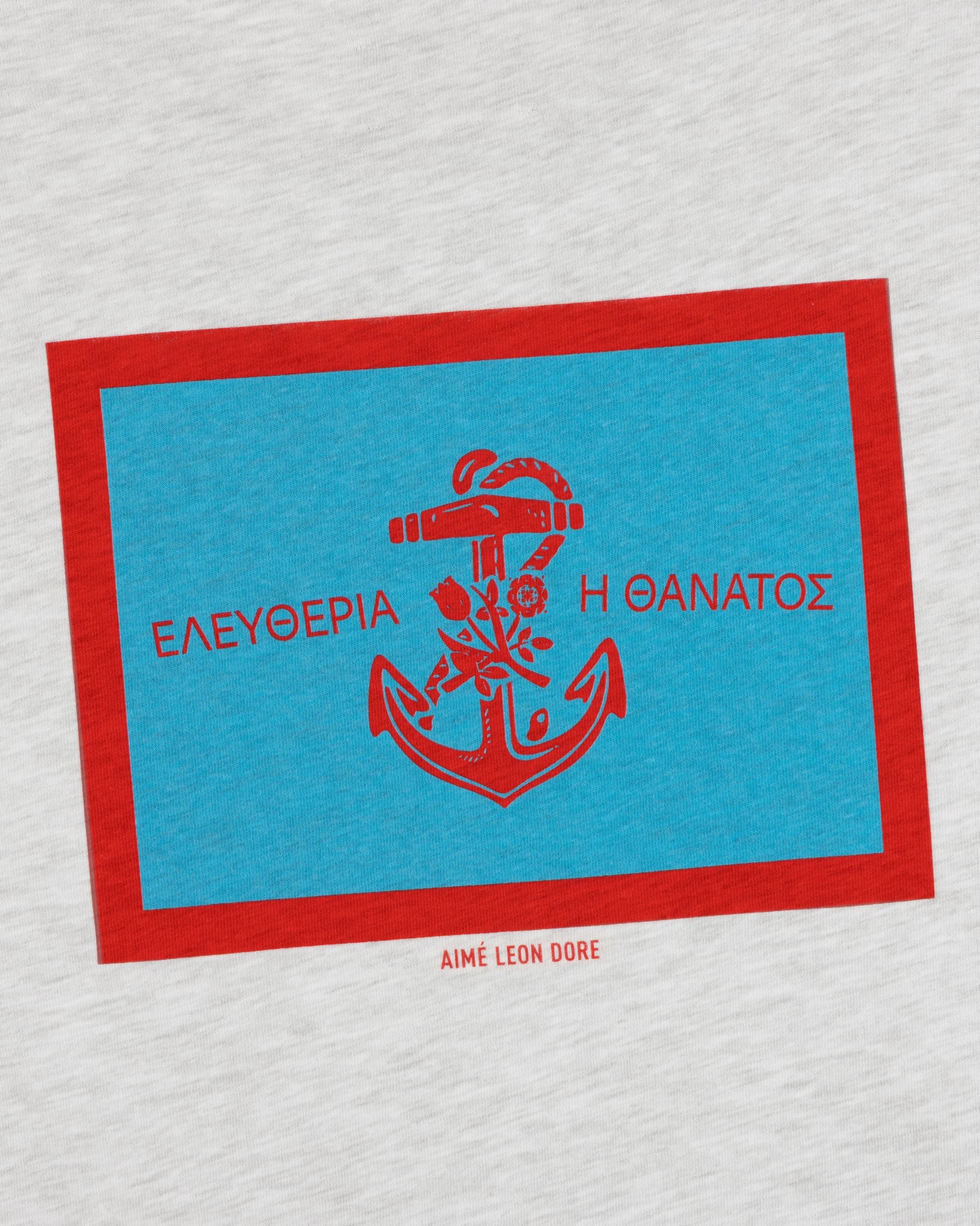 A blue and red anchor graphic with Greek text and Aimé Leon Dore on the light gray Coastal Flag Tee.
