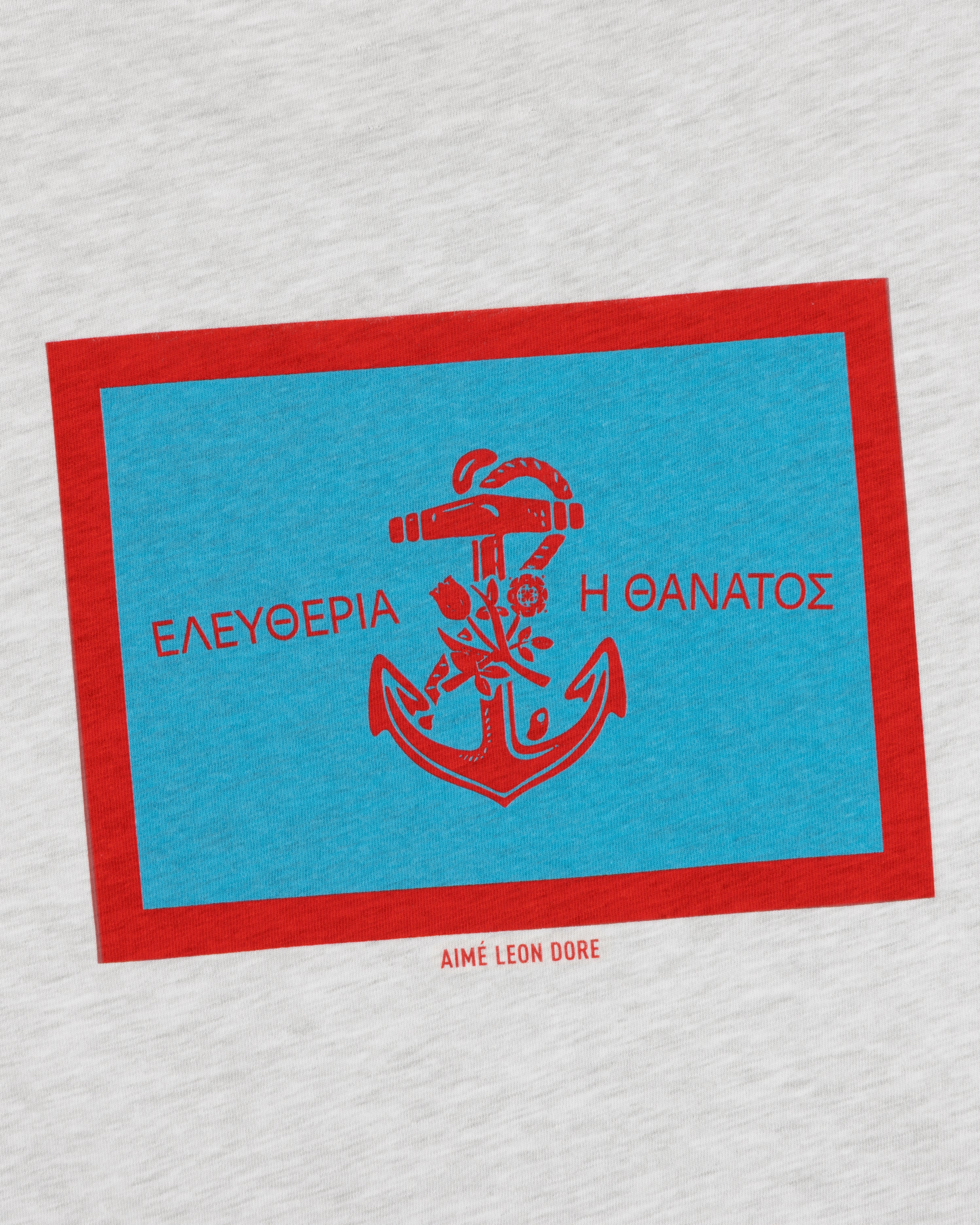 A blue and red anchor graphic with Greek text and Aimé Leon Dore on the light gray Coastal Flag Tee.