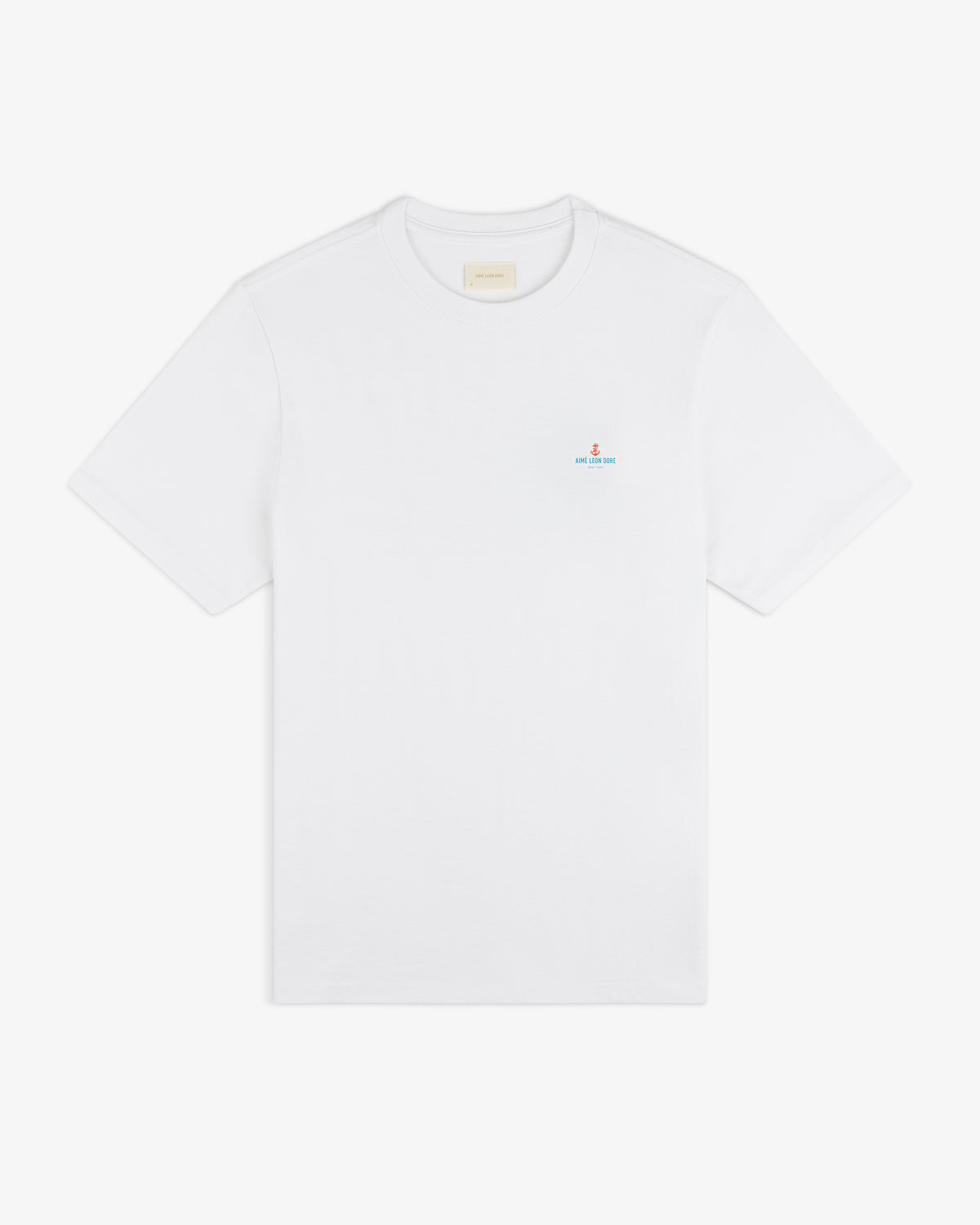 Coastal Flag Tee: plain white short-sleeve t-shirt with small blue and red text logo on left chest.