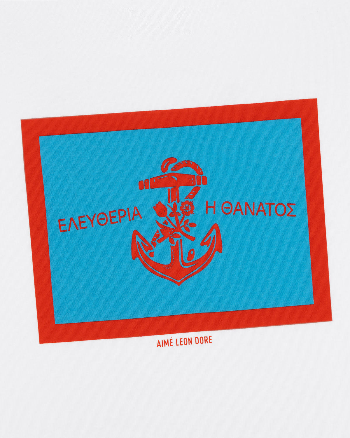 A red anchor with Greek text on a blue rectangle, framed in red, features on the Coastal Flag Tee.