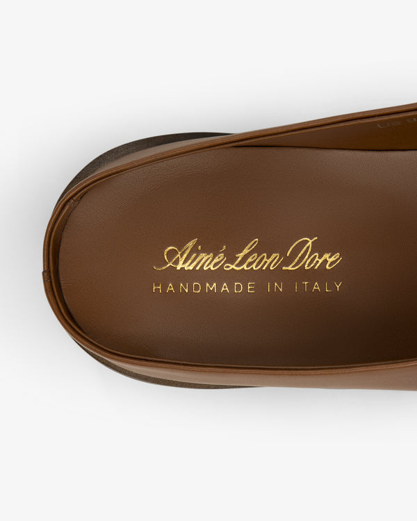 Venetian Mule brown leather sandal insole features "Aimé Leon Dore HANDMADE IN ITALY" in gold lettering.