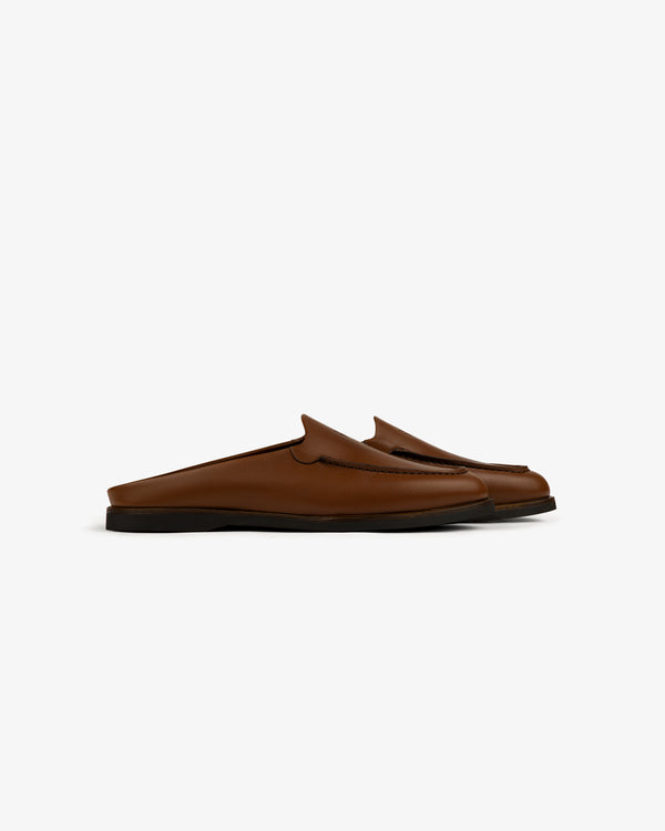 Venetian Mule brown leather slip-on loafers with black soles, backless design, side view on white background.