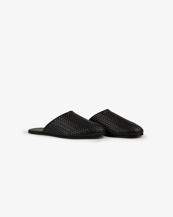 A pair of Leather Raffia Mule slip-on slippers in black with closed toes, shown on a plain white background.