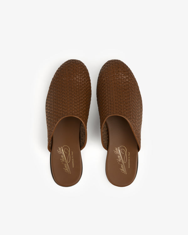 A top view of Leather Raffia Mule slip-on shoes in brown with flat soles on a white background.