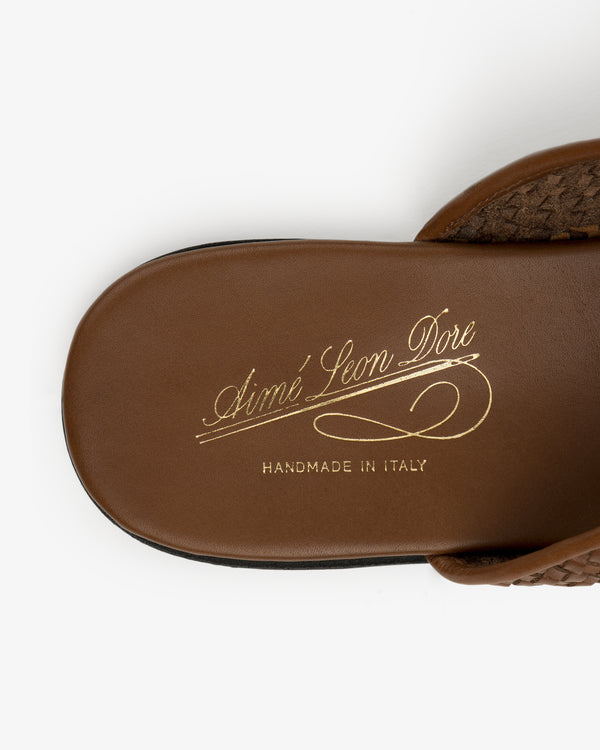 Close-up of a brown Leather Raffia Mule with HANDMADE IN ITALY in gold script on the insole.
