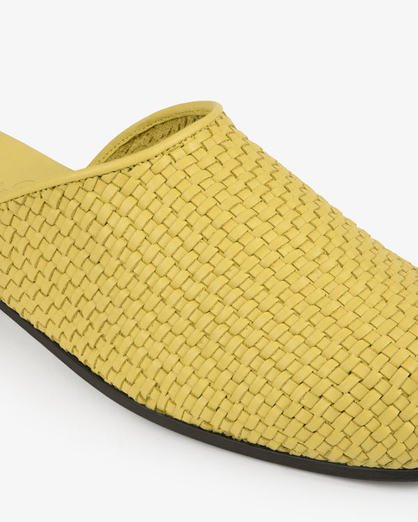 Leather Raffia Mule in yellow with black sole, slip-on style, shown against a white background.