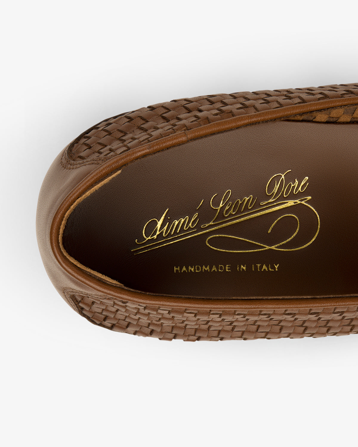 Leather Raffia Loafer in brown woven leather with “Aimé Leon Dore Handmade in Italy” gold text on the insole, top view.