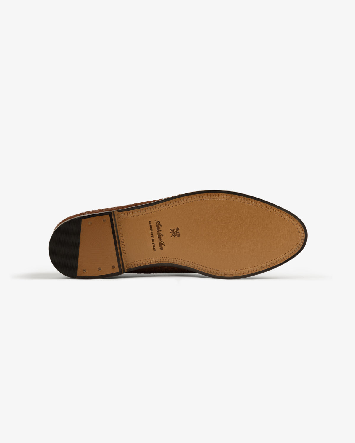 The image shows the tan leather sole of the Leather Raffia Loafer with stitching and a small heel, viewed from below.