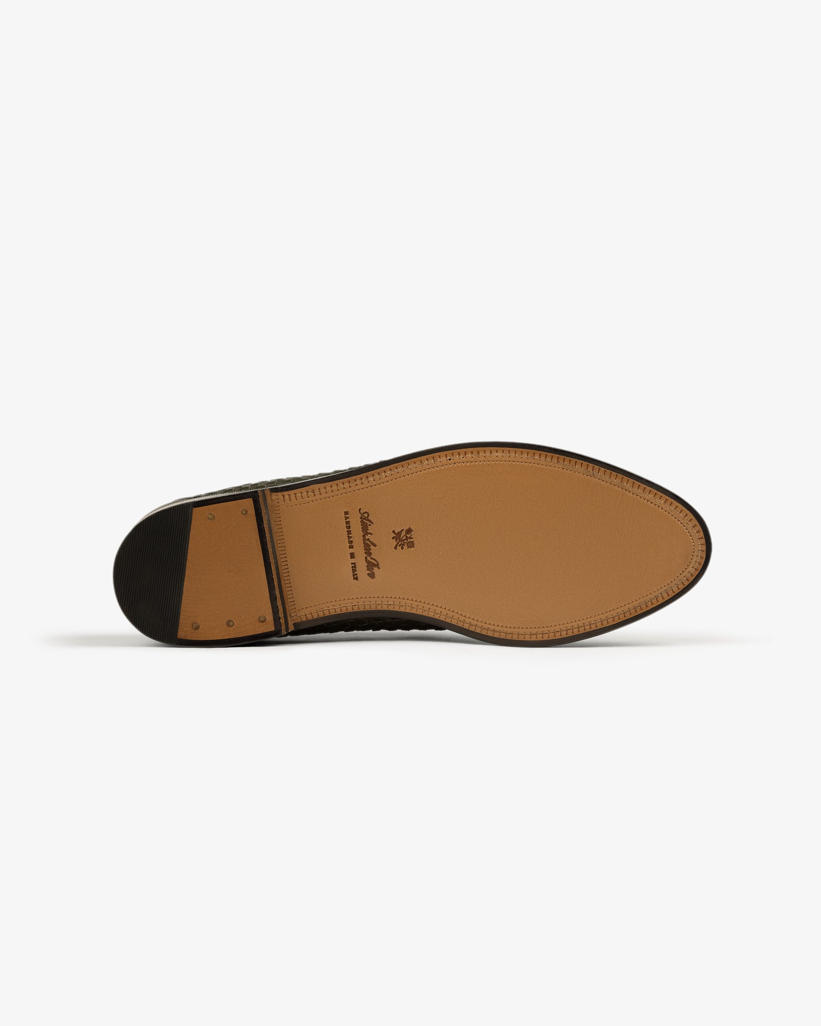 Tan leather and black heel detailing on the sole of the Leather Raffia Loafer, shown from the bottom.