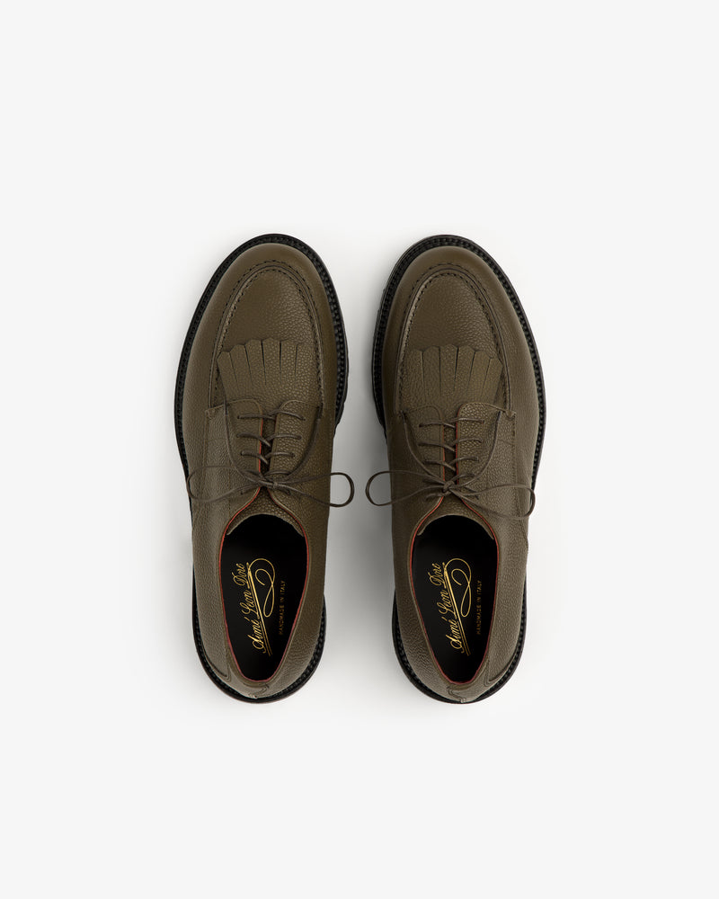 Top view of Leather Lug Sole Derby in olive green leather with laces and fringe, on a white background.