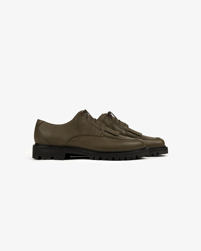 A pair of Leather Lug Sole Derby shoes in olive green leather with black chunky soles, shown on a white background.