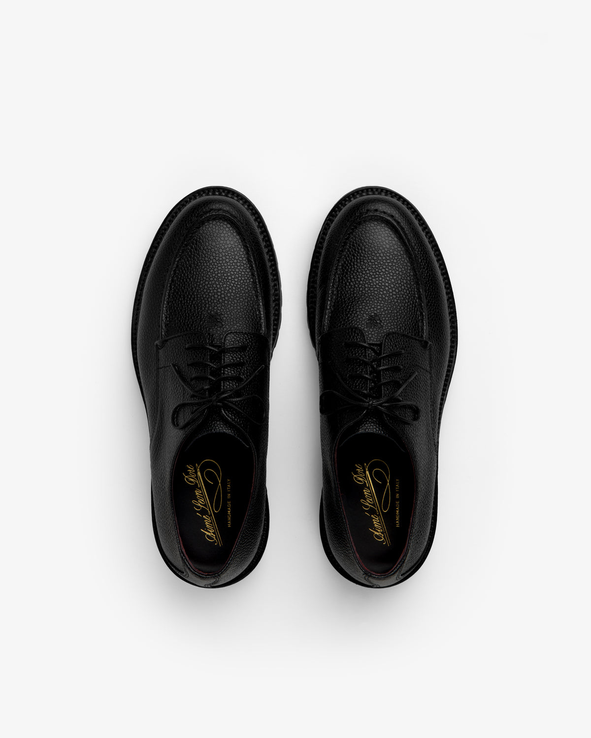 Pair of black textured Leather Lug Sole Derby shoes with thick lug soles, viewed from above.