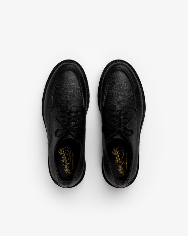 Pair of black textured Leather Lug Sole Derby shoes with thick lug soles, viewed from above.
