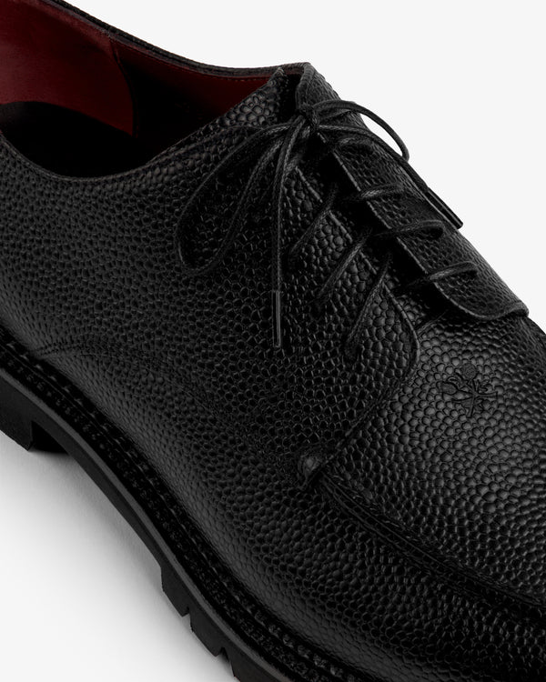 Leather Lug Sole Derby: black textured leather lace-up shoe with a thick lug sole and maroon interior.