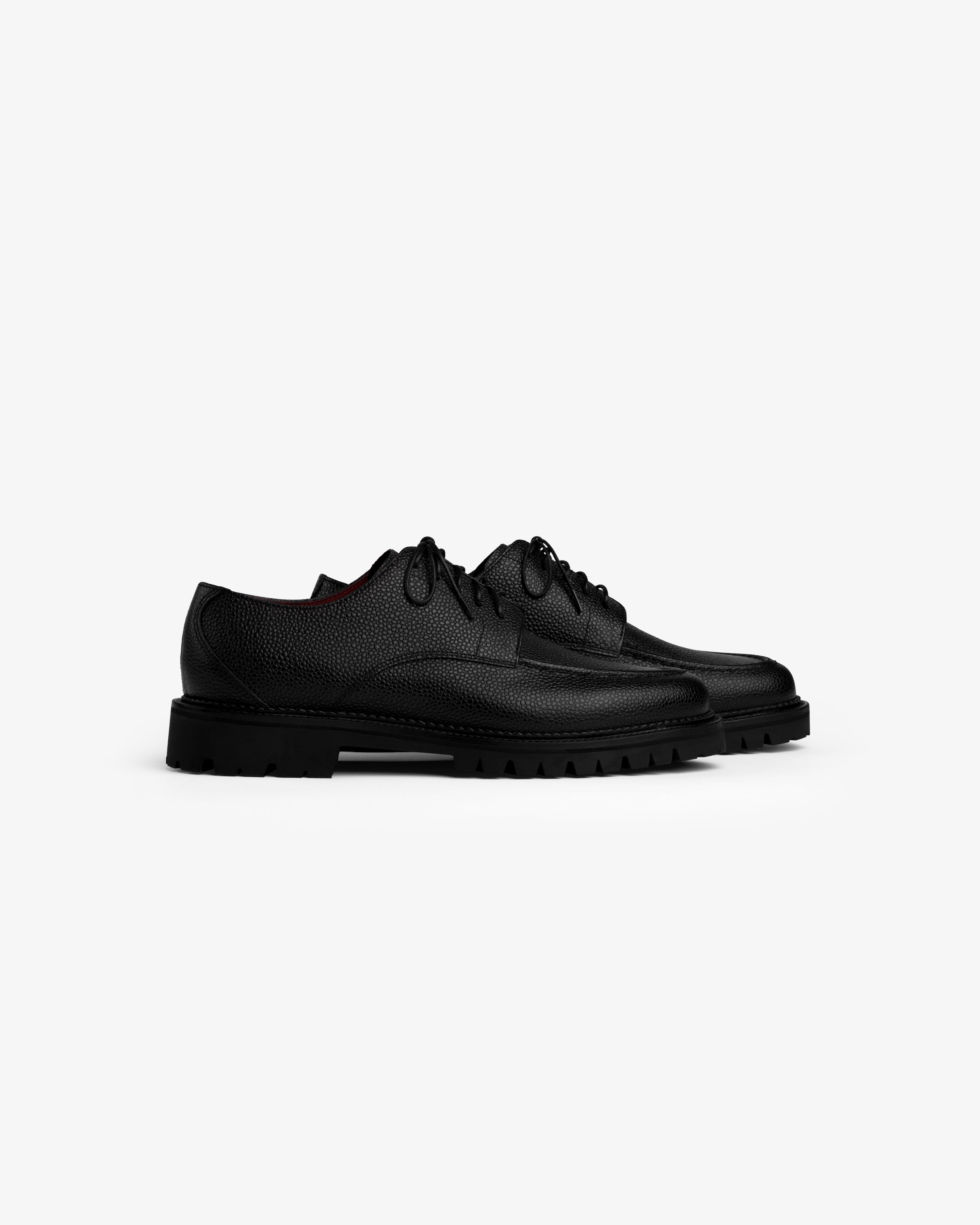 Leather Lug Sole Derby shoes in black leather with thick, notched rubber soles.