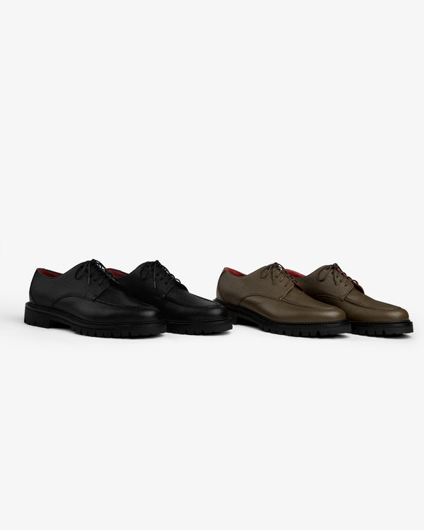 A black and a brown Leather Lug Sole Derby, both with black lug soles.